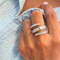 A sculptural three-row diamond wrap ring in 18K white gold featuring baguette and round diamonds. Designed to be worn, not reserved. Luxury that moves with you.