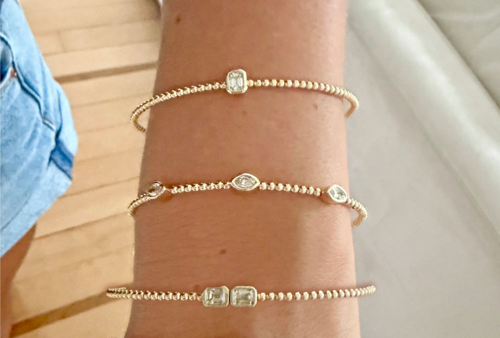 Set of stacked yellow gold and diamond bangle bracelets.