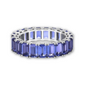 A white gold tanzanite eternity ring, shown on a clean white background.