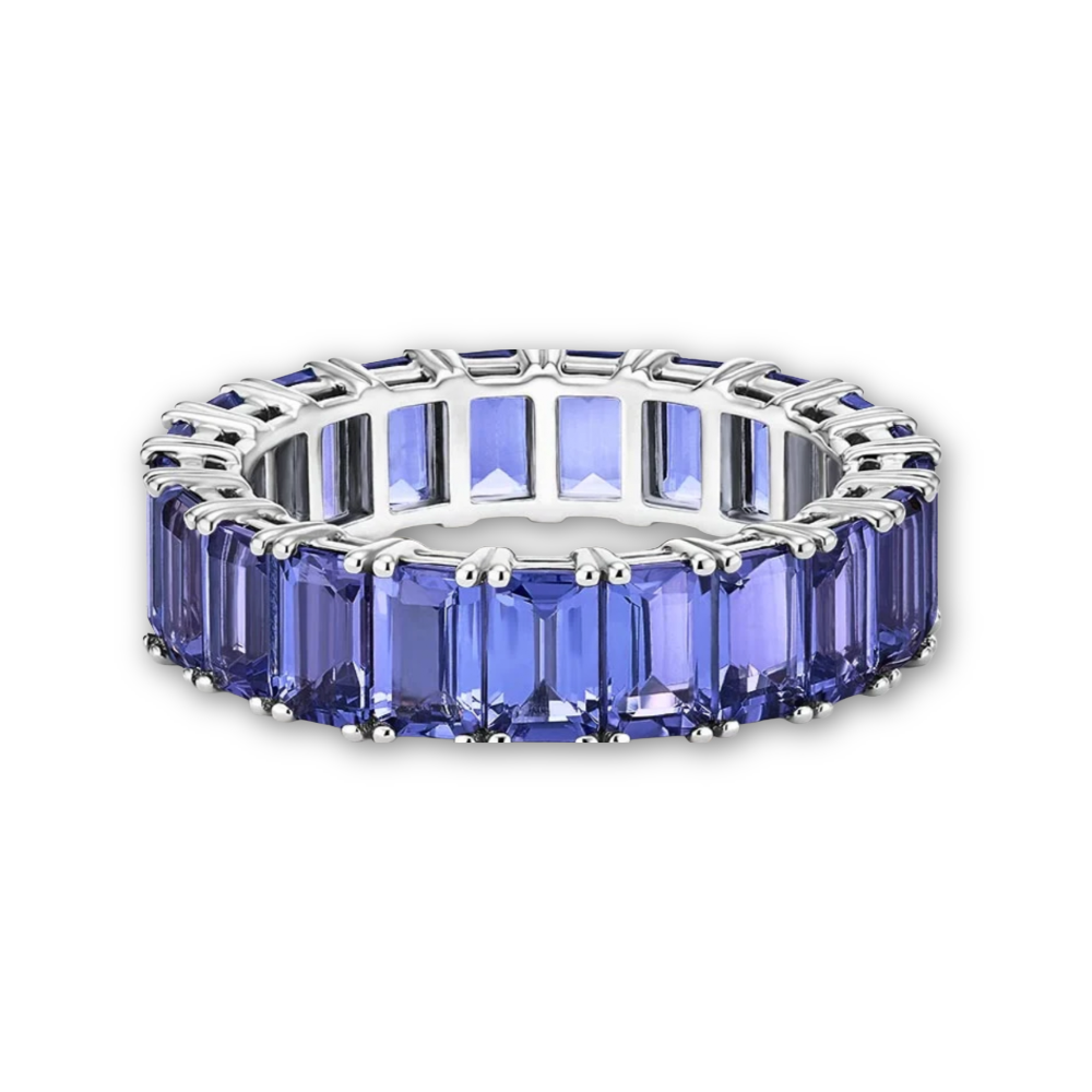 A white gold tanzanite eternity ring, shown on a clean white background.