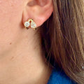 Embrace bezel-set diamond stud earrings in 18K yellow gold featuring round brilliant natural diamonds.