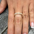 Continuum diamond eternity ring featuring natural diamonds set continuously around an 18K gold band, shown worn on a hand.