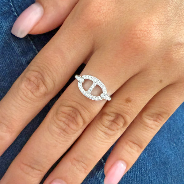 Close-up of a sculptural open oval diamond ring in white gold on a woman's hand, featuring a pavé diamond open-circle design for refined everyday wear.