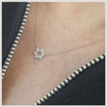 Magen diamond pendant featuring a diamond-set six-pointed star on a fine gold chain, worn at the neckline.